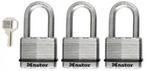 Three silver padlocks in a row with a key on the left side.