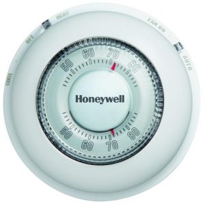 Round Honeywell thermostat with temperature control dial.