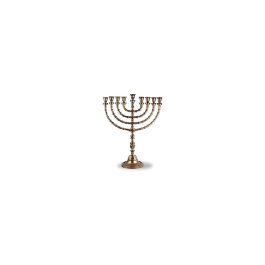 Antique brass menorah with nine branches isolated on a light background.