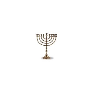 Antique brass menorah with nine branches isolated on a light background.
