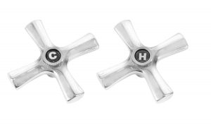 Two silver cross-shaped faucet handles marked with "C" for cold and "H" for hot.