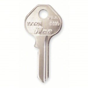 A single metal key with embossed text, isolated on a white background.