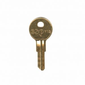 A brass door key isolated on a white background.