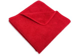 A neatly folded red bath towel isolated on a white background.