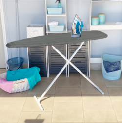 An ironing board with a modern design and an iron on top, situated in a neat laundry room.