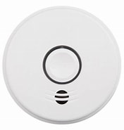 White smoke detector on a plain background.