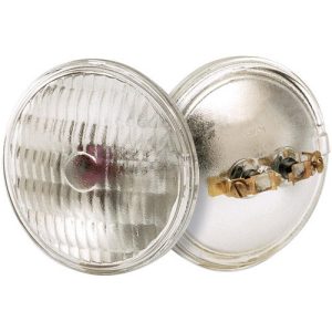 A sealed beam headlight with a clear glass lens and metal back.