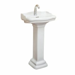White pedestal sink with faucet on a blank background.