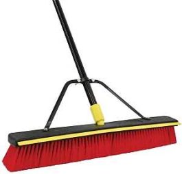 Industrial push broom with red bristles and a black and yellow handle on a white background.