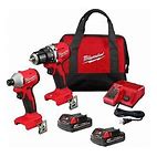 Milwaukee power tool set including a drill, impact driver, batteries, charger, and a carrying bag.
