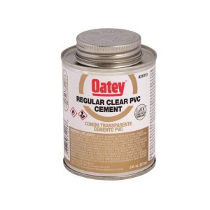 Can of Oatey regular clear PVC cement with safety and product information labels.